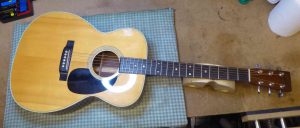 Martin acoustic guitar on the bench prior to the new bone nut and saddle being fitted