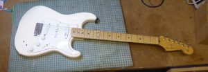 White U S Fender Stratocaster on the bench awaiting a service and setup