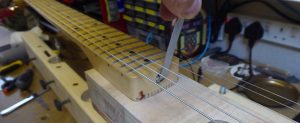 Adjusting the truss rod on the heel of a Stratocaster neck whilst bolted on to a Stew Macdonald neck jig