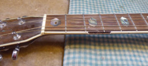 broken neck binding on an acoustic guitar