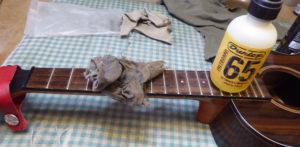Applying lemon oil to the fretboard of a ukulele