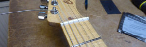 Photograph of the new bone nut with strings fitted