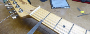 Assessing the action height at the first fret